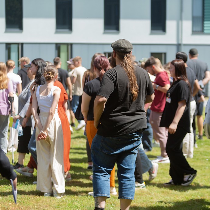 Das Bild zeigt viele Personen auf einer Wiese (vergrößerte Bildansicht wird geöffnet)